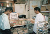 The bookshop goes unnoticed by tourists because it is not located at the port or near popular tourist attractions.