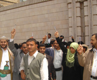 Against the savage mercenaries, journalists and activists hold pens high as a sign of peaceful protest through media.