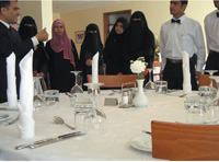 Students learn about table-setting techniques.