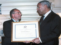 Ambassador Edward Skip Gnehm received the Secretarys Distinguished Service Award from Secretary of State Colin L. Powell in August 2004. (The Eliot School of International Affairs)