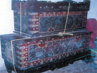Distinctive ornamentation on wooden boxes.