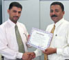 Aden Bureau Chief, Rhidwan Al-Saqqaf (left) hands over Saeed Ali Maiteb the certificate of appreciation