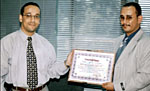 Mr. Waheeb al-Harawi (left) receives certificate