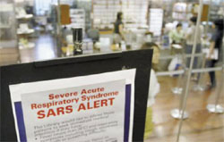 A medical advisory on the flu-like Severe Acute Respiratory Syndrome (SARS) is displayed at the entrance to a public library in Singapore,  April 11. 	REUTERS