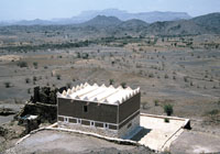 A plain stretches before the mosque giving view of a series of mountains. The mosque is believed to have been built in a spot where there used to stand a pre-Islamic temple.