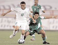 Saudi Arabias Mohammed Al-Shalhoub (left) fights for the ball withYemens Nashwan Al-Hajjam (right) during the 17th Arabian Gulf Cup
