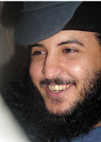 Suspect Fawaz al-Rabii seen here smiling during the trial as he admitted his connection to Osama bin Laden but denied killing soldier Hameed Khasroof. (Yemen Times photo)