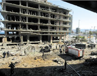 The scene of the damaged area, Feb. 15, where a massive car bomb blew up the motorcade of former prime minister Rafik al-Hariri on Beiruts seafront yesterday. REUTERS
